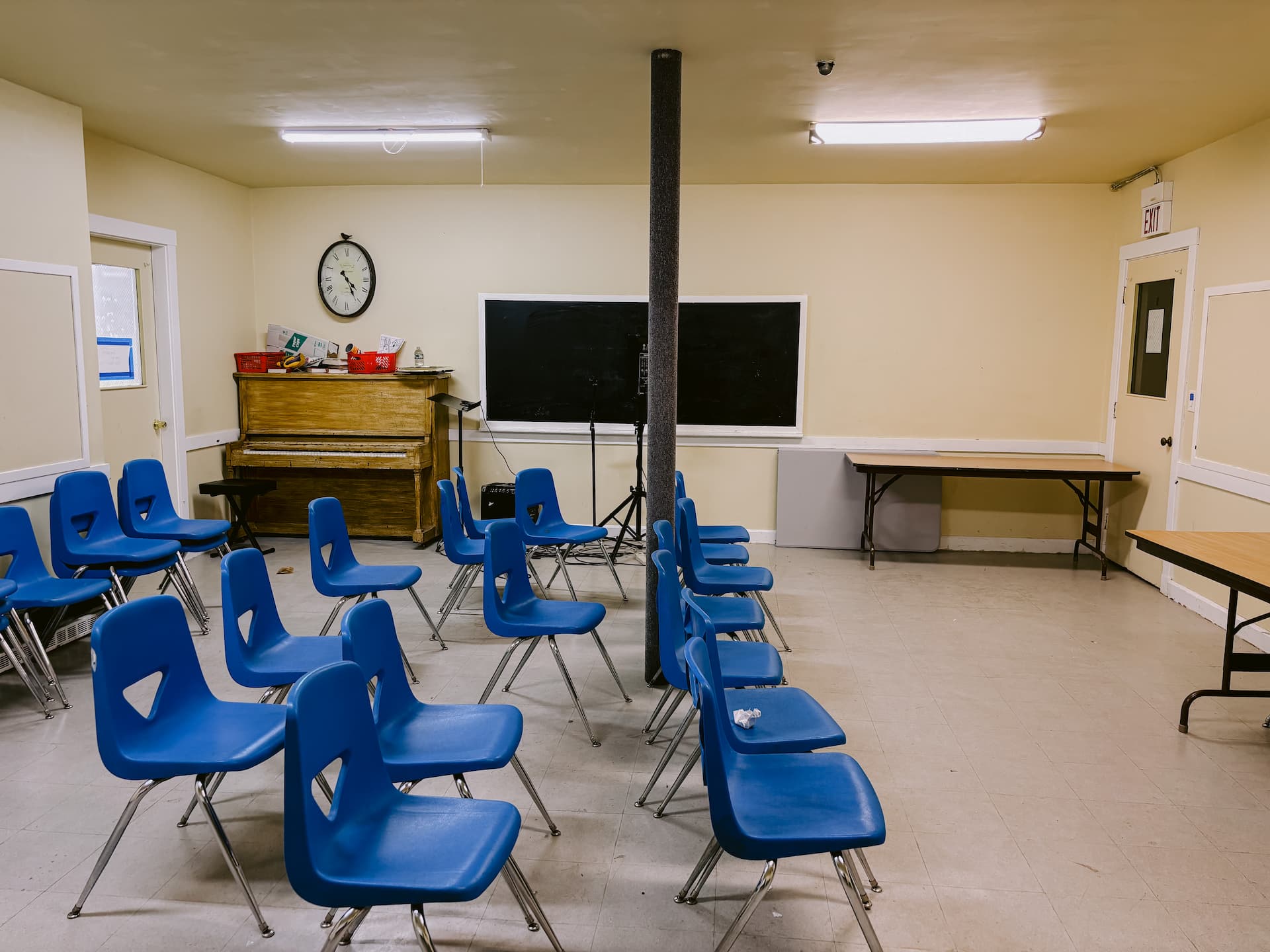 Classroom with blue chairs and piano